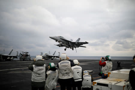 FILE PHOTO - A U.S. F18 fighter jet lands on the deck of U.S. aircraft carrier USS Carl Vinson during an annual joint military exercise called "Foal Eagle" between South Korea and U.S., in the East Sea, South Korea, March 14, 2017. REUTERS/Kim Hong-Ji/File Photo