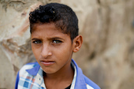 Hamza Shayaa, 11, a cousin of ten-year-old malnourished girl Afaf Hussein, stands outside Afaf's family's home in the village of al-Jaraib, in the northwestern province of Hajjah, Yemen, February 19, 2019. Afaf, who now weighs around 11 kg and is described by her doctor as "skin and bones", has been left acutely malnourished by a limited diet during her growing years and suffering from hepatitis, likely caused by infected water. She left school two years ago because she got too weak. REUTERS/Khaled Abdullah