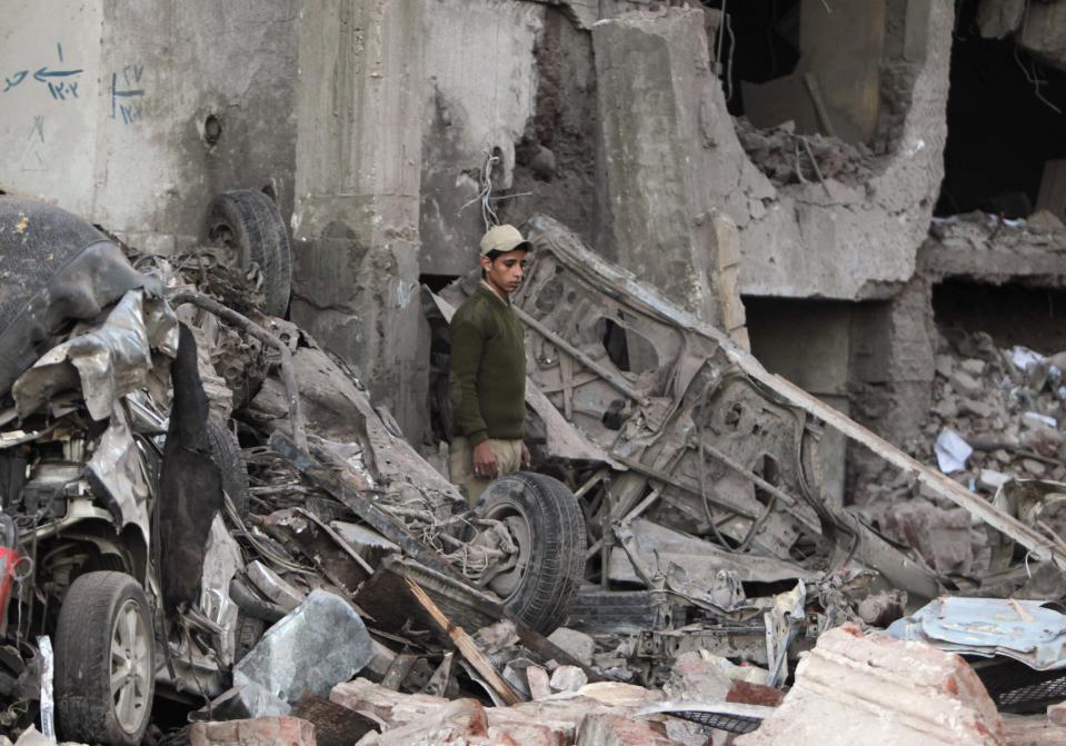 A police officer stands outside building of Directorate of Security after explosion in Egypt's Nile Delta town of Dakahlyia