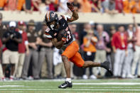 Oklahoma State wide receiver Brennan Presley (80) runs after catching the ball in the first half of an NCAA college football game against Oklahoma Saturday, Nov. 4, 2023, in Stillwater, Okla. (AP Photo/Mitch Alcala)