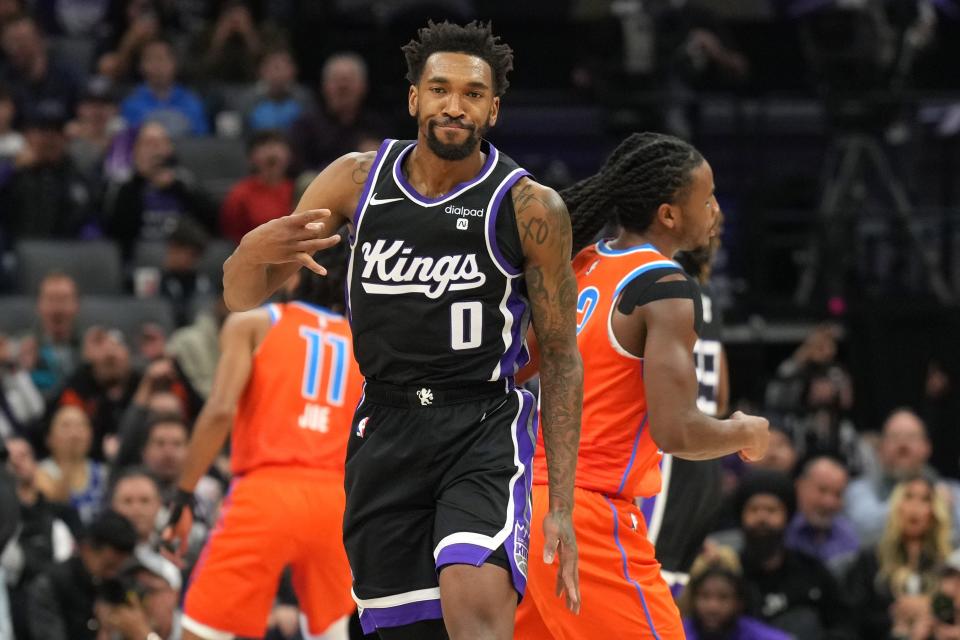 Dec 14, 2023; Sacramento, California, USA; Sacramento Kings guard Malik Monk (0) gestures after making a three point basket against the Oklahoma City Thunder during the third quarter at Golden 1 Center. Mandatory Credit: Darren Yamashita-USA TODAY Sports