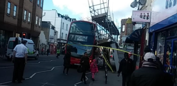 Scaffolding collapses on double decker bus in London