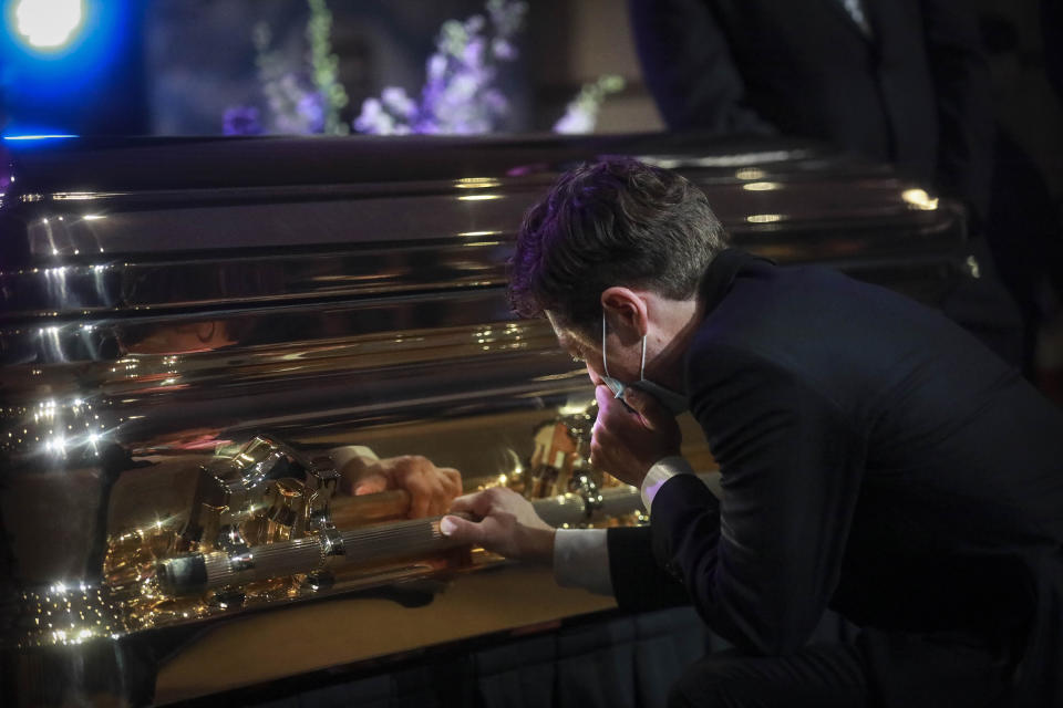 FILE - In this June 4, 2020 file photo, Minneapolis Mayor Jacob Frey kneels and weeps by the casket of George Floyd before a memorial service in Minneapolis. Talk of changing the Minneapolis Police Department is everywhere in the wake of Floyd's death in an encounter with four officers. But real change may depend on confronting the powerful police union that has resisted similar attempts for years. Local politicians and police leaders have long blamed an entrenched culture in the department and the union. (AP Photo/Bebeto Matthews File)