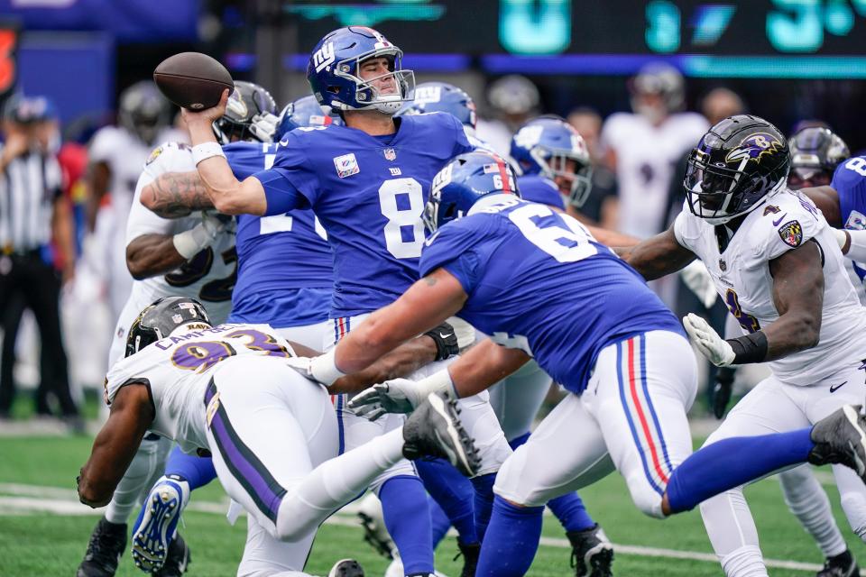 New York Giants quarterback Daniel Jones (8) throws a pass as Baltimore Ravens' Calais Campbell (93) pressures him during the first half of an NFL football game Sunday, Oct. 16, 2022, in East Rutherford, N.J. (AP Photo/Seth Wenig)