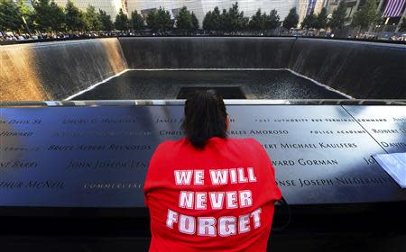 A woman pauses for reflection at the 9/11 Memorial during ceremonies marking the 12th anniversary of the 9/11 attacks on the World Trade Center in New York. September 11, 2013. REUTERS/Alejandra Villa/Pool