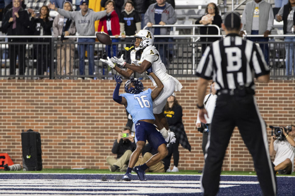 Appalachian State wide receiver Dalton Stroman, center top, reaches for the ball as he is defended by Old Dominion cornerback Khian'Dre Harris (16) during the second half of an NCAA college football game Saturday, Oct. 21, 2023, in Norfolk, Va. (AP Photo/Mike Caudill)