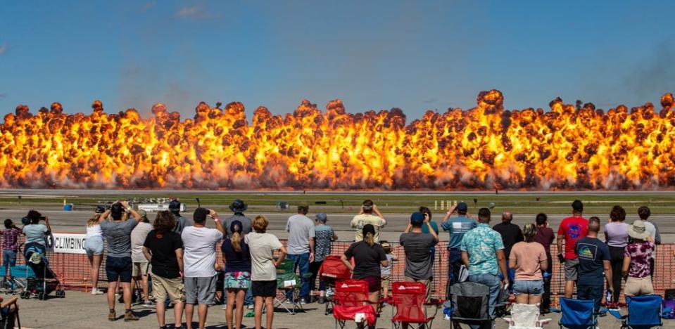 The audience watches as the Wall of Fire - a pyrotechnic blast conducted by Marine Corps Air Station (MCAS) Cherry Point Explosive Ordnance Disposal technicians - sets the sky ablaze during the Marine Air Ground Taskforce demonstration at the 2021 MCAS Cherry Point Air Show and 80th Anniversary Celebration, Sept. 26, 2021.
