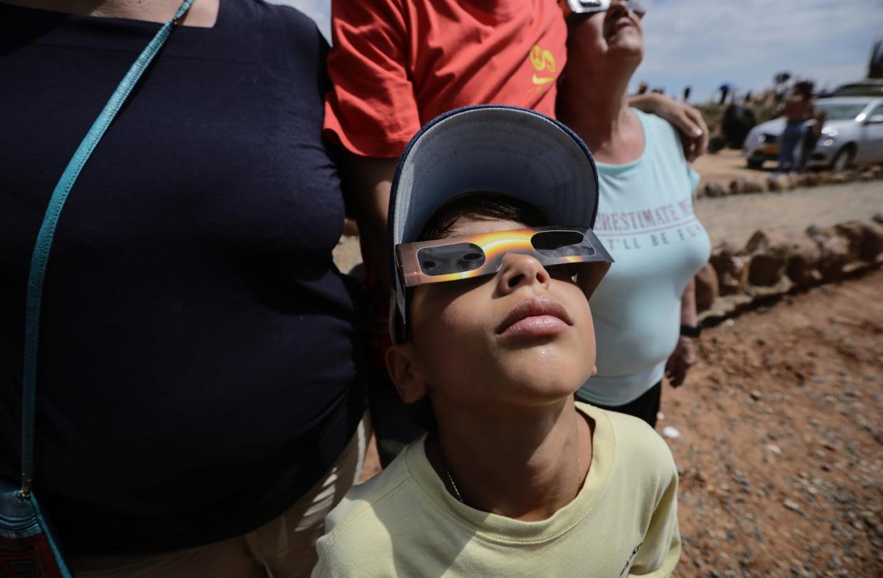 In no case should a child look directly at the solar eclipse, but there are special eclipse glasses. <a href="https://www.gettyimages.com/detail/news-photo/child-observes-the-annular-solar-eclipse-by-using-special-news-photo/1724609614?adppopup=true" rel="nofollow noopener" target="_blank" data-ylk="slk:Anadolu via Getty Images;elm:context_link;itc:0;sec:content-canvas" class="link ">Anadolu via Getty Images</a>