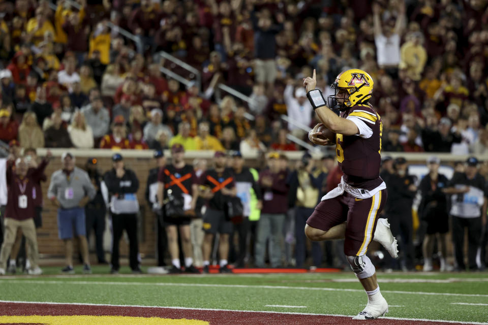 Minnesota quarterback Max Brosmer (16) scores a touchdown during the second half of an NCAA college football game against Southern California Saturday, Oct. 5, 2024, in Minneapolis. (AP Photo/Ellen Schmidt)