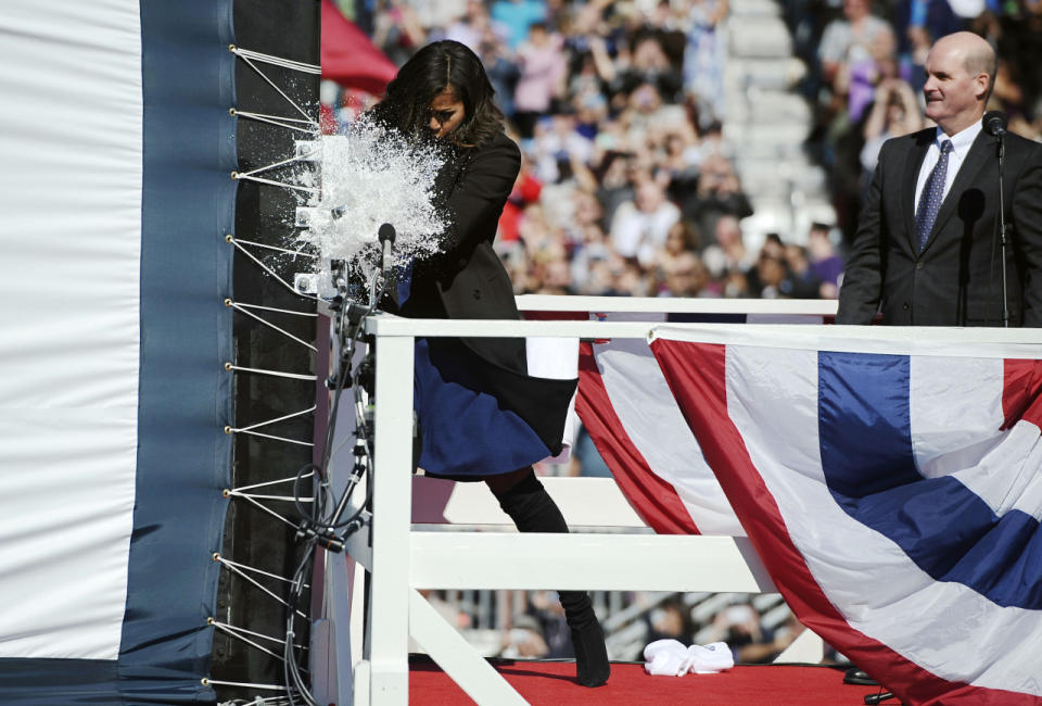 First lady Michelle Obama christens the USS Illinois with a bottle of sparkling wine.