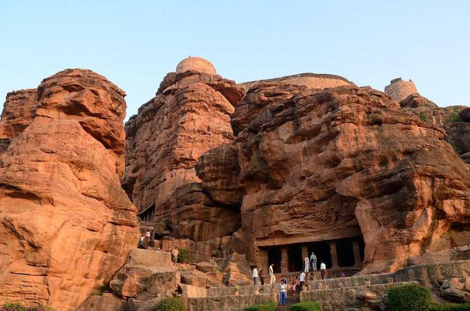 The jagged outline of the sandstone turns a deep red in the evening light