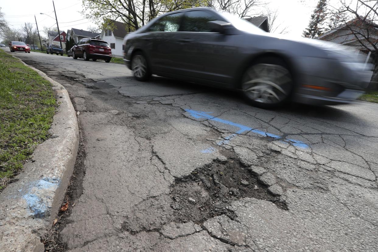 FILE - A pothole at the corner of Wisconsin Street and Annex Avenue in Oshkosh is shown in this file photo.