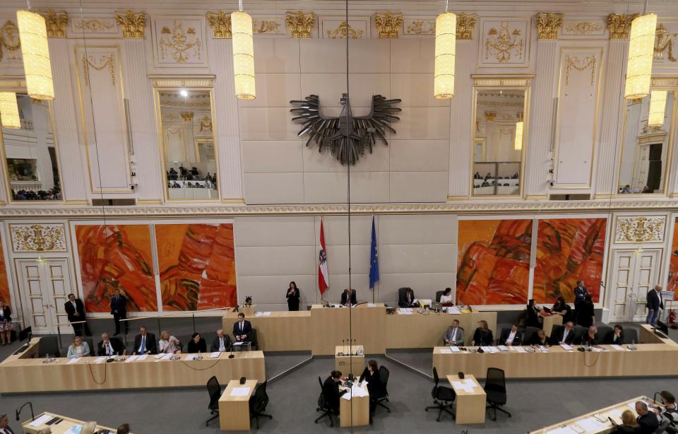 Austrian Chancellor Sebastian Kurz, at the left podium right, delivers his speech at parliament session in Vienna, Austria, Monday, May 27, 2019. Chancellor Sebastian Kurz faces a no-confidence vote at the parliament session. (AP Photo/Ronald Zak)