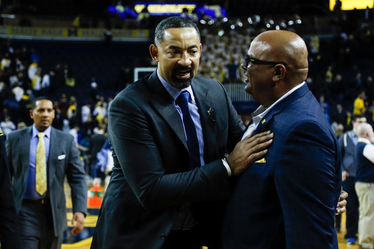 Michigan head coach Juwan Howard is congratulated by athletic director Warde Manuel after 84-78 win over Purdue at Crisler Center in Ann Arbor, Thursday, Jan. 9, 2020.