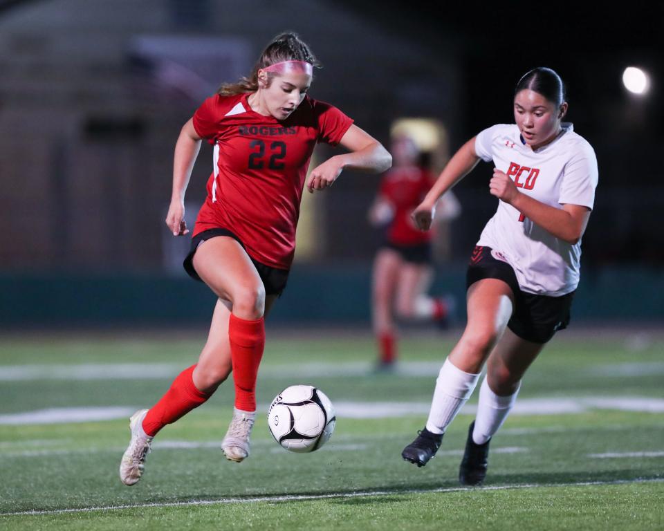 Rogers' Fallon Bagley pushed the ball up the field against a PCD defender on Saturday night.
