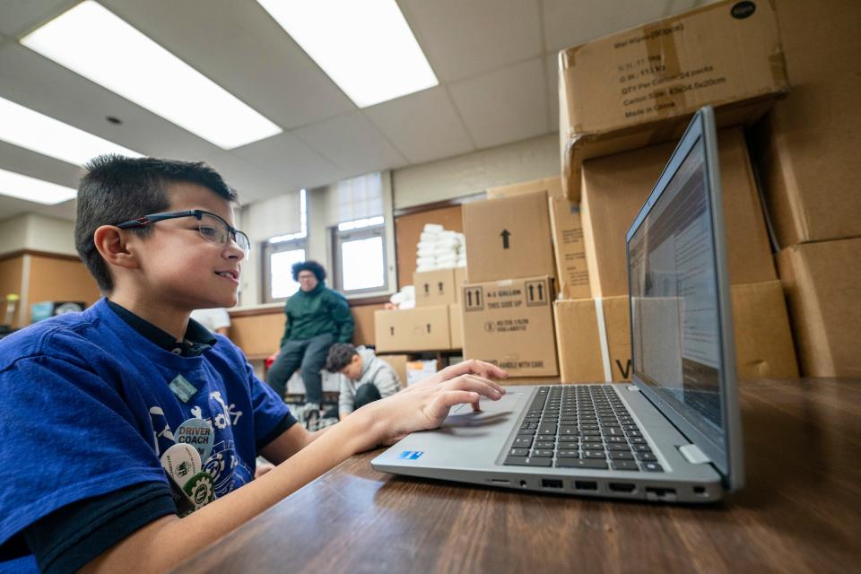 Southwest Detroit's Clippert Multicultural Magnet Honors Academy student Andrzej Sanchez, 11, works on code as he works with his robotics team for an upcoming competition Tuesday, Nov. 22, 2022.