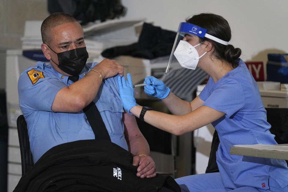 New York City firefighter emergency medical services personnel are vaccinated against COVID-19 at the FDNY Fire Academy in New York, Wednesday, Dec. 23, 2020. (AP Photo/Seth Wenig)