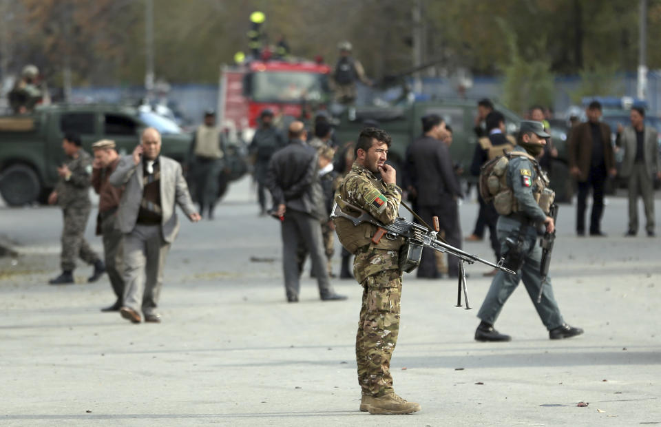 Security forces inspect the site of a deadly blast near a demonstration by hundreds of minority Shiites, in the center of Kabul, Afghanistan, Monday, Nov. 12, 2018. Afghan officials confirmed several people were killed in the explosion near a high school and about 500 meters (yards) from where people gathered to denounce Taliban attacks in Jaghuri and Malistan districts of eastern Ghazni province. (AP Photo/Massoud Hossaini)