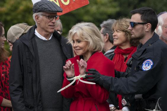 Jane Fonda, joined by Ted Danson, is arrested at the Capitol after she and other demonstrators called on Congress for action to address climate change, in Washington, DC on 25 October, 2019. (AP Photo/J Scott ApplewhiteAP)