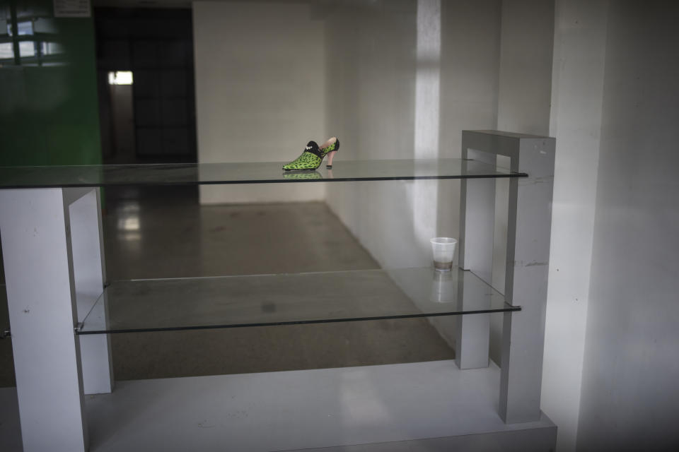 A lone shoe sits on a display table at a store that was unable to reopen after the mall where it is located was looted during nation-wide blackouts in Maracaibo, Venezuela, Nov. 21, 2019. For many in Maracaibo, Venezuela's economic crash in the last five years hit especially hard. (AP Photo/Rodrigo Abd)