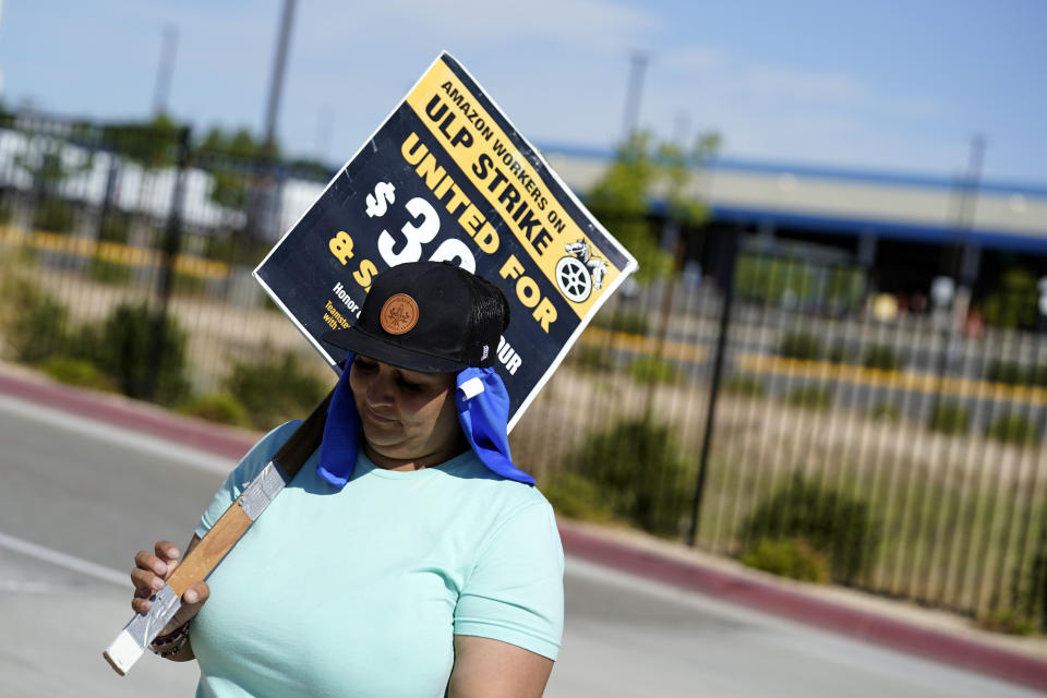 Brandi Diaz pickets outside one of the Amazon's distribution centers Monday, July 24, 2023, in Palmdale, Calif. Dozens of Amazon drivers and dispatchers who work for a California-based delivery firm the Teamsters unionized in April have been picketing company warehouses, calling on the e-commerce behemoth to come to the table and bargain over pay and working conditions. (AP Photo/Marcio Jose Sanchez)