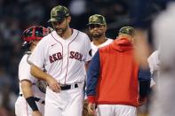 Boston Red Sox's Michael Wacha leaves the mound after being removed by manager Alex Cora, right, during the fifth inning of the team's baseball game against the Seattle Mariners, Friday, May 20, 2022, in Boston. (AP Photo/Michael Dwyer)