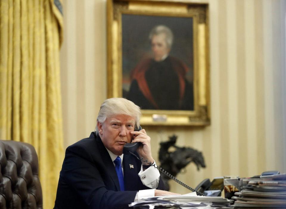In this 2017 photo, Donald Trump speaks on the telephone in the Oval Office with a portrait of former president Andrew Jackson in the background. Trump installed the painting in the first few days of his administration. (AP Photo/Alex Brandon)
