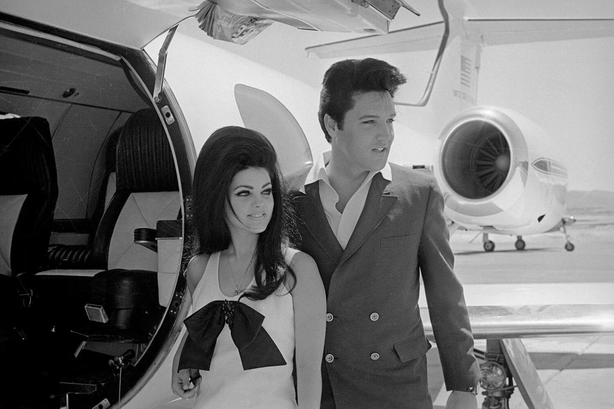 Newlyweds Elvis and Priscilla Presley, who met while Elvis was in the Army, prepare to board their private jet following their wedding at the Aladdin Resort and Casino in Las Vegas.