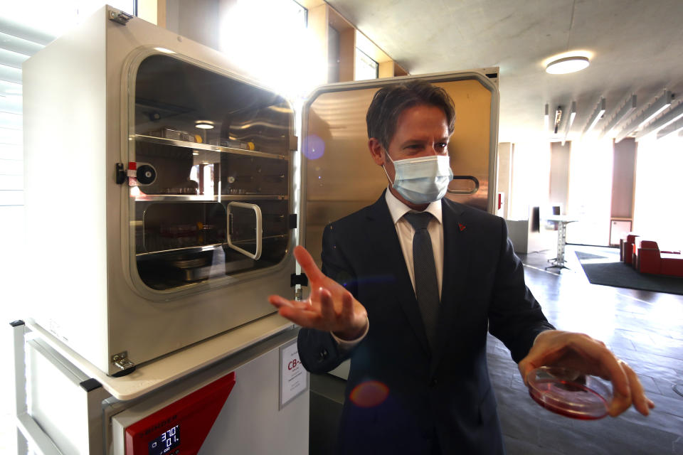 File -- In this Tuesday, Nov. 24, 2020 file photo Peter Wimmer, Vice President of Binder, the world's largest manufacturer of serial-production environmental simulation chambers for scientific or industrial laboratories, poses at an ultra low temperature freezer in Tuttlingen, Germany. Germany prepares for the vaccination of the German population during the upcoming month. (AP Photo/Matthias Schrader, file)