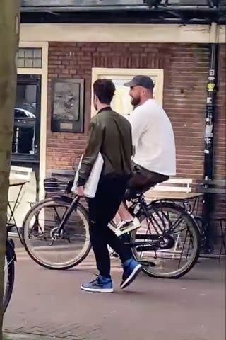 <p>Mark Gray for PEOPLE</p> Travis Kelce bikes in Amsterdam on July 6, 2024