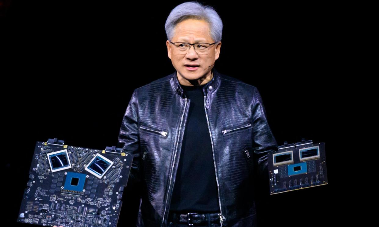 <span>Nvidia's CEO Jensen Huang displays products on-stage during the annual Nvidia GTC Artificial Intelligence Conference at SAP Center in San Jose, California, on 18 March 2024. </span><span>Photograph: Josh Edelson/AFP/Getty Images</span>