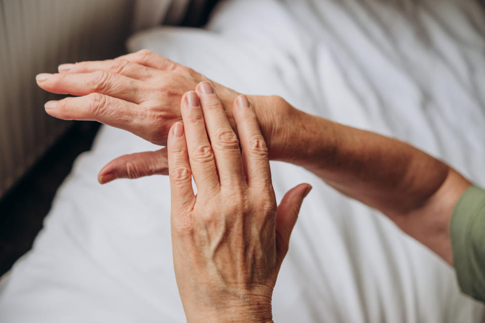 woman rubbing dry oil on her hand