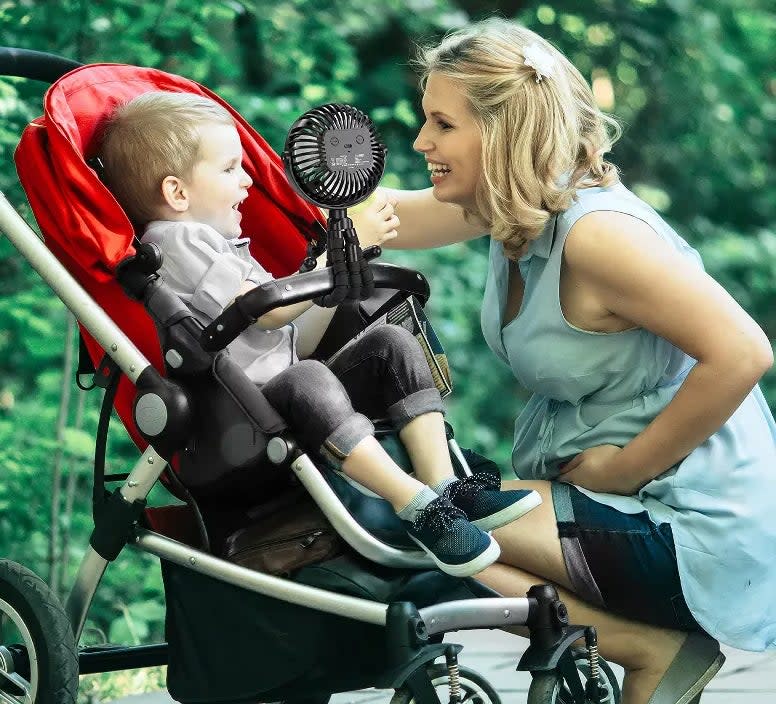 Black fan attached to stroller