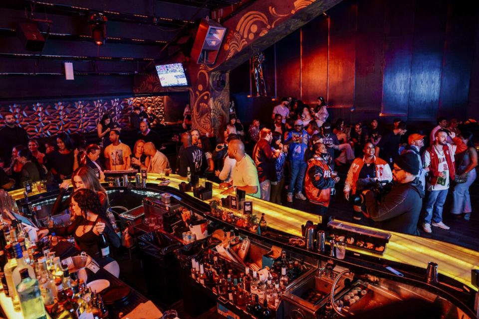 Fans crowd around the bar at a nightclub in the basement of the Miami Heat's arena.