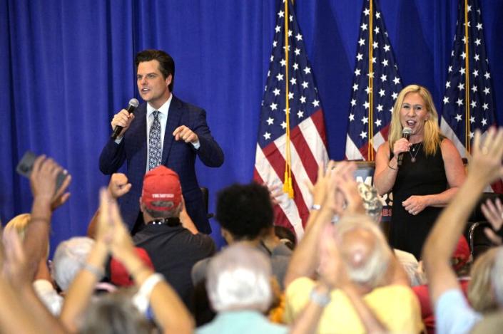 Rep. Matt Gaetz, R-Fla., left, and Rep. Marjorie Taylor Greene, R-Ga., address attendees at a rally in Florida in May.