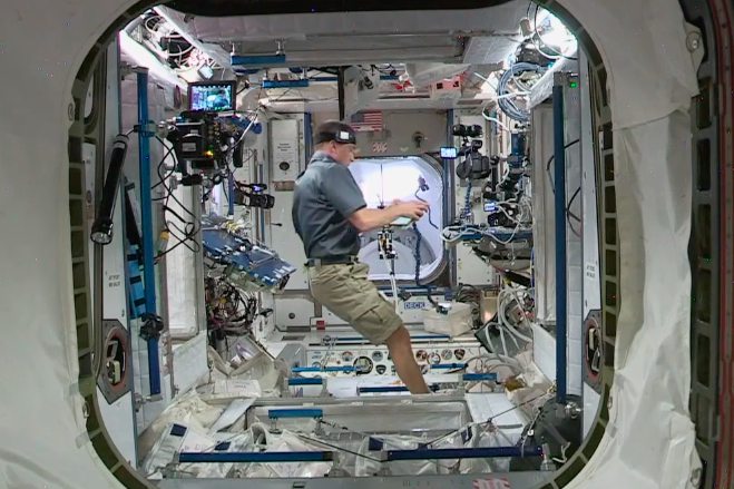 Chris Cassidy prepares the hatch door through to the ISS (NASA TV)