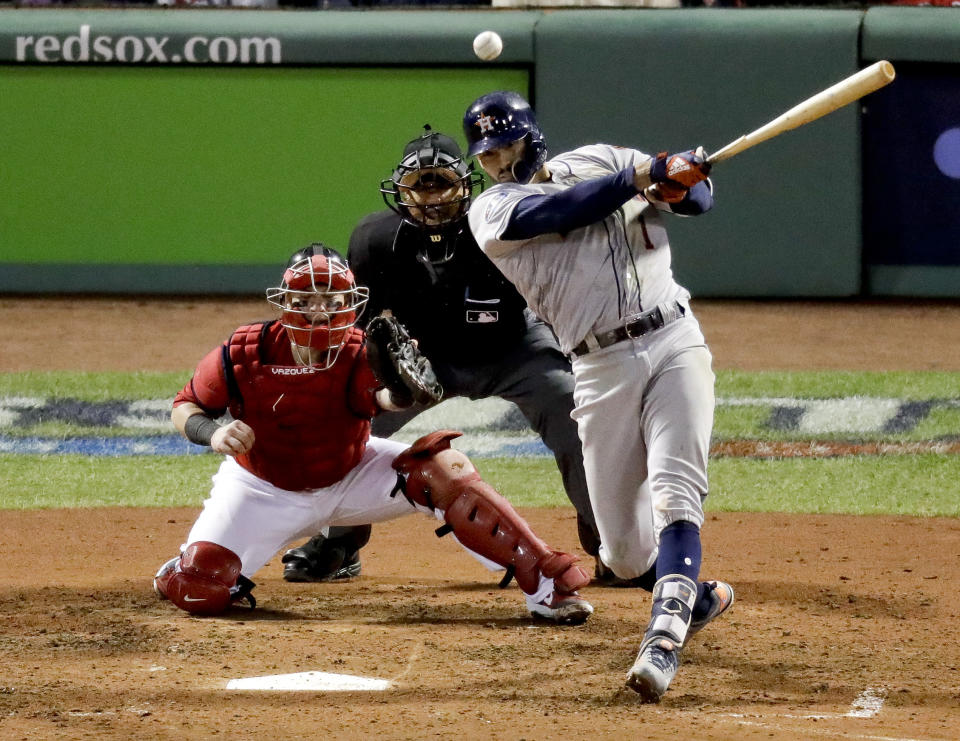 Houston Astros' Carlos Correa watches his RBI-single against the Boston Red Sox during the sixth inning in Game 1 of a baseball American League Championship Series on Saturday, Oct. 13, 2018, in Boston.(AP Photo/Elise Amendola)