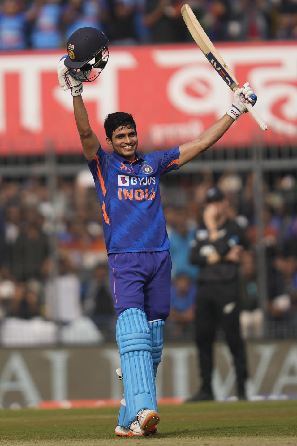 India's Shubhman Gill raises his bat to celebrate scoring a century during the third one-day international cricket match between India and New Zealand in Indore, India, Tuesday, Jan. 24, 2023. (AP Photo/Rajanish Kakade)