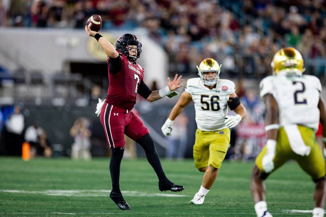 Dec 30, 2022; Jacksonville, FL, USA; South Carolina Gamecocks quarterback Spencer Rattler (7) throws the ball under pressure during the second half against the Notre Dame Fighting Irish in the 2022 Gator Bowl at TIAA Bank Field. Mandatory Credit: Matt Pendleton-USA TODAY Sports
