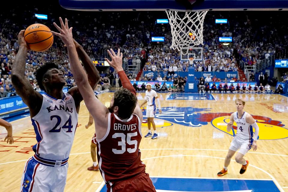 Kansas forward K.J. Adams Jr. (24) shoots over Oklahoma forward Tanner Groves (35) during the first half of an NCAA college basketball game Tuesday, Jan. 10, 2023, in Lawrence, Kan. (AP Photo/Charlie Riedel)