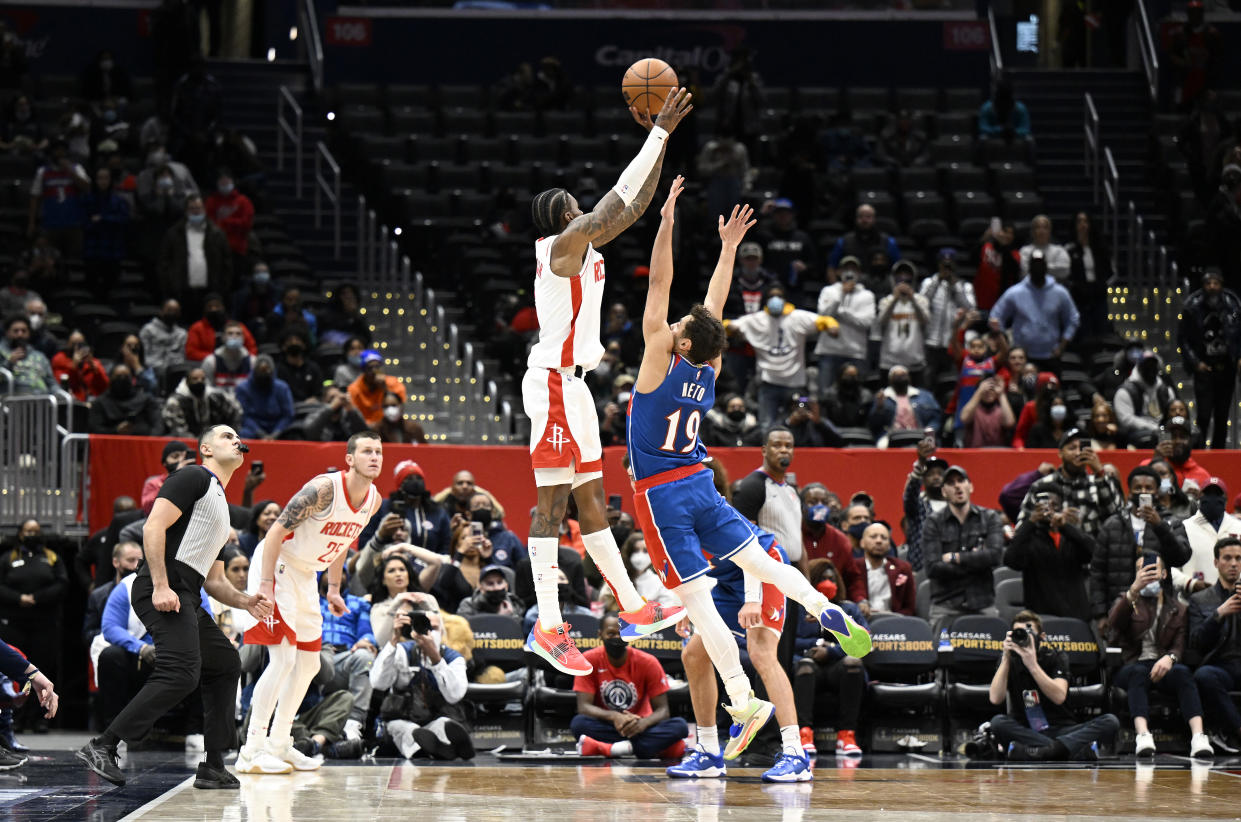 WASHINGTON, DC - JANUARY 05: Kevin Porter Jr. #3 of the Houston Rockets shoots the game-winning shot over Raul Neto #19 of the Washington Wizards at Capital One Arena on January 05, 2022 in Washington, DC. Houston won the game 114-111. NOTE TO USER: User expressly acknowledges and agrees that, by downloading and or using this photograph, User is consenting to the terms and conditions of the Getty Images License Agreement. (Photo by G Fiume/Getty Images)