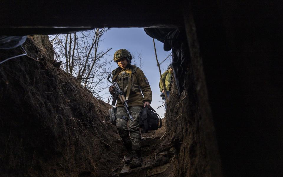 Soldiers from a Ukrainian assault brigade enter a command bunker in the trenches near Bakhmut - John Moore/Getty Images Europe