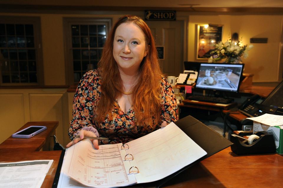 Jessica Prichard works the front desk at Longfellow's Wayside Inn in Sudbury, Jan. 25, 2022.