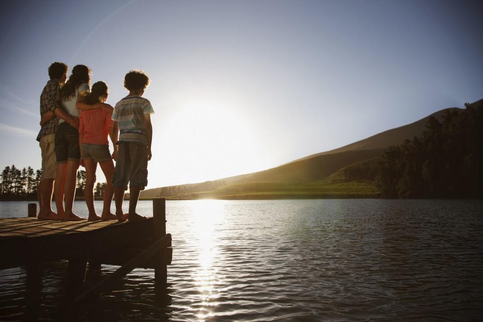 summer activities family on dock watching sun set on lake