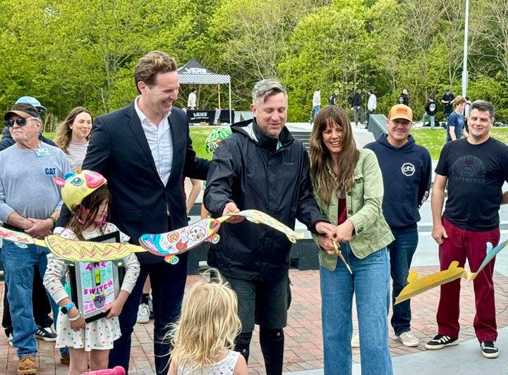 Mayor Deaglan McEachern, left, and Portsmouth Skate Park Volunteer Committee co-chairs Amy-May Court and Dave Cosgrove cut the ribbon at the new park Saturday, May 18, 2024.