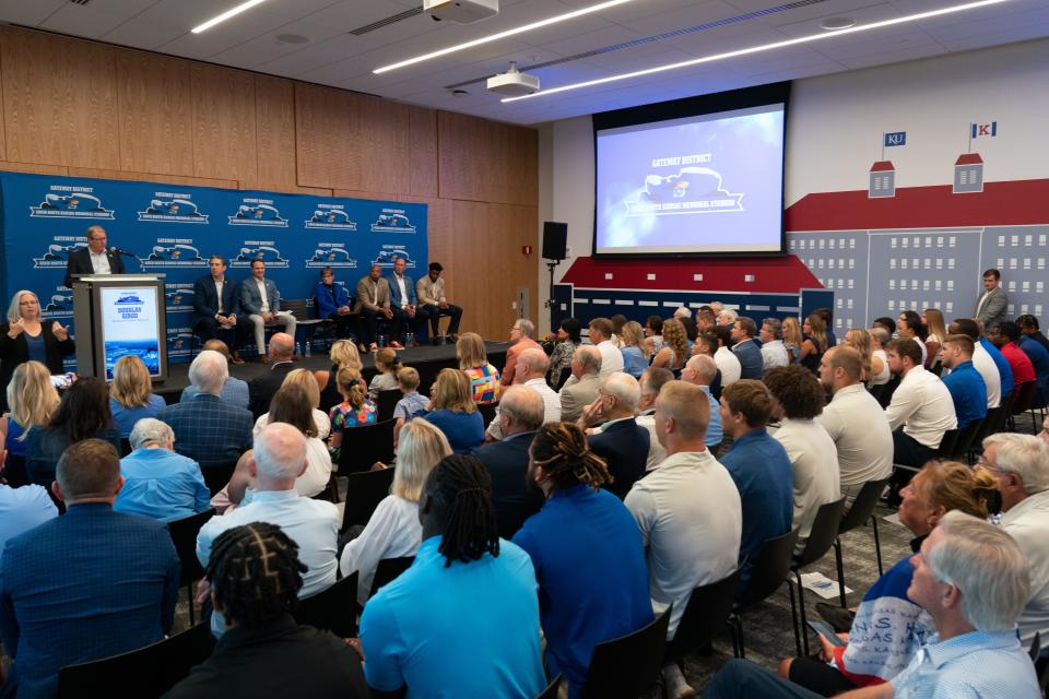 A packed room in the University of Kansas Welcome Center listens to chancellor Douglas Girold speak about the new Gateway District during Tuesday's unveil event.