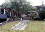 ADDS NAME OF THE POLICE OFFICER HOMEOWNER - The house owned by Lawrence Police Officer Ivan Soto sits nearly burned to the ground on Jefferson Street, in Lawrence, Mass., Friday, Sept. 14, 2018. It was one of multiple houses that went up in flames on Thursday afternoon after gas explosions and fires triggered by a problem with a gas line that feeds homes in several communities north of Boston. After rushing home to check on his family and warn his neighbors to evacuate, Soto went back on patrol while his house was burning down. (AP Photo/Mary Schwalm)