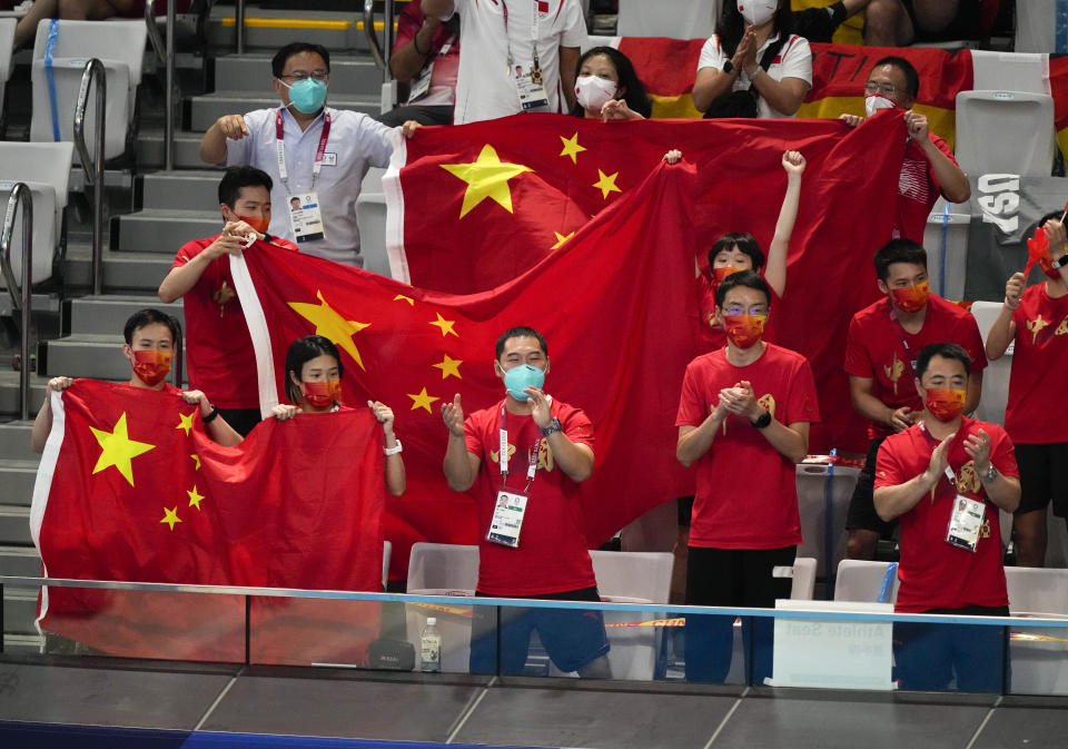 China's team supporters cheer Quan Hongchan of China during women's diving 10m platform final at the Tokyo Aquatics Centre at the 2020 Summer Olympics, Thursday, Aug. 5, 2021, in Tokyo, Japan. (AP Photo/Dmitri Lovetsky)