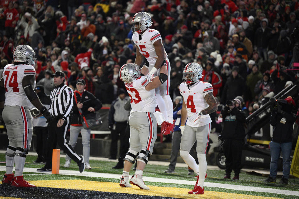 Ohio State running back Dallan Hayden (5) celebrates his touchdown with offensive lineman Luke Wypler (53), wide receiver Julian Fleming (4) and offensive lineman Donovan Jackson (74) against Maryland on Saturday in College Park, Maryland. (AP Photo/Nick Wass)