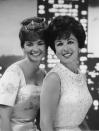 <p>Former Miss Americas, Vonda Kay Van Dyke (1965) and Bess Myerson (1945), strike a pose in embroidered evening gowns, while attending the 1966 Miss America pageant. </p>